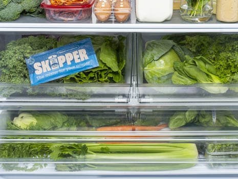 An image showing the inside of a fridge with all the crisper drawers full of vegetables. One of the drawers has a Skipper pack inside